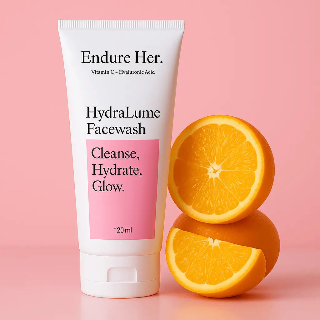 Tube of 'Endure Her' HydraLume Facewash with oranges on a pink background